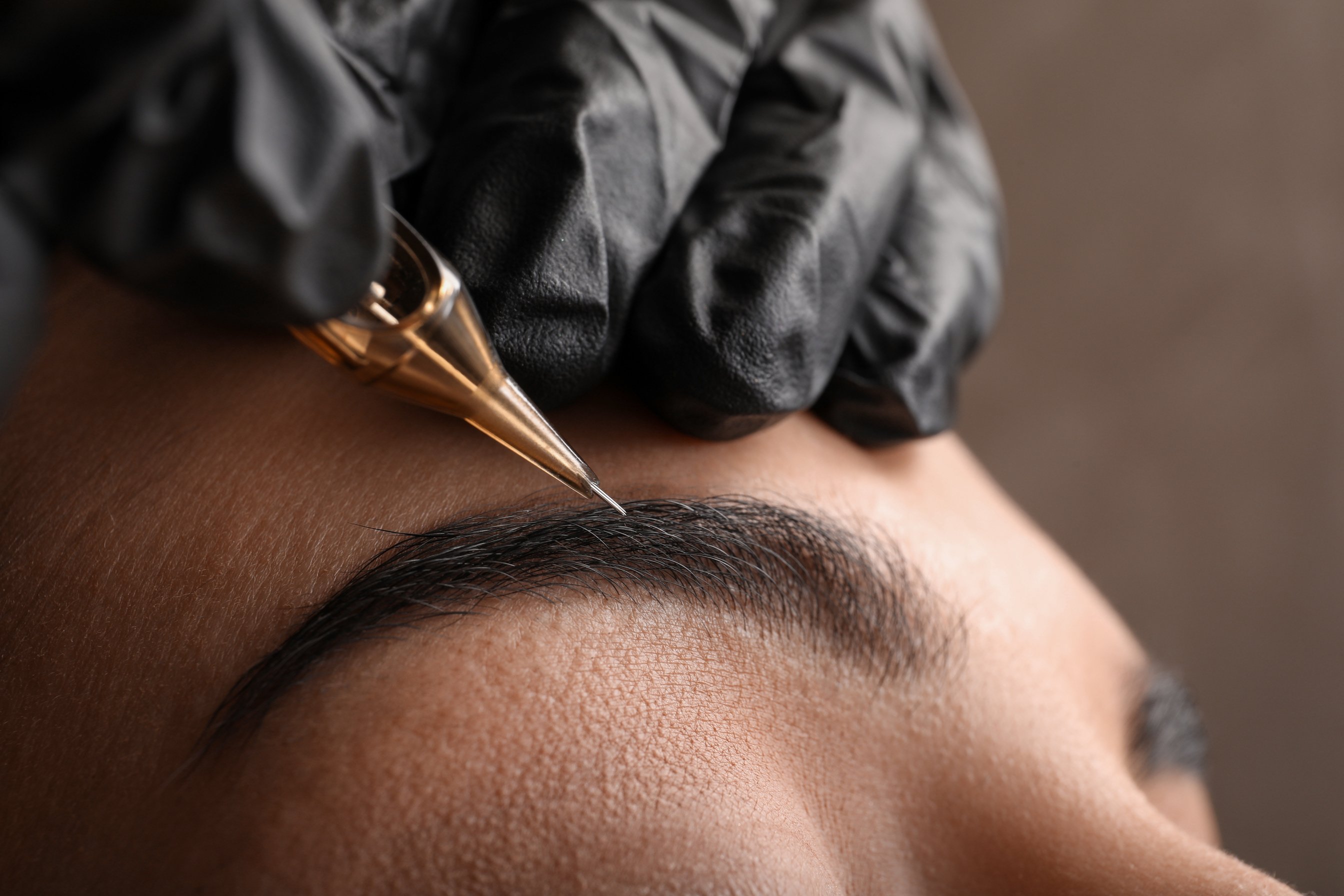 Young Woman Undergoing Procedure of Permanent Eyebrow Makeup in